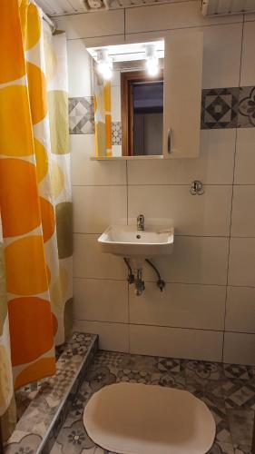 a bathroom with a sink and a mirror at Haus Maria in Nea Potidaea