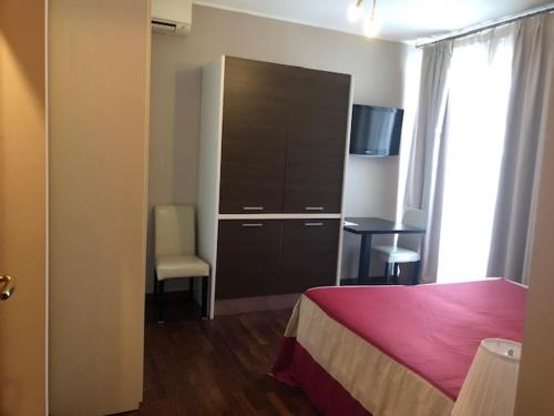 a bedroom with a bed and a dresser and a desk at Residenza Segrate Centro Segrate in Segrate