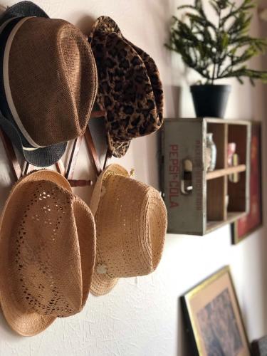 a group of hats hanging on a wall at Ballygally Seaview Cottage in Larne