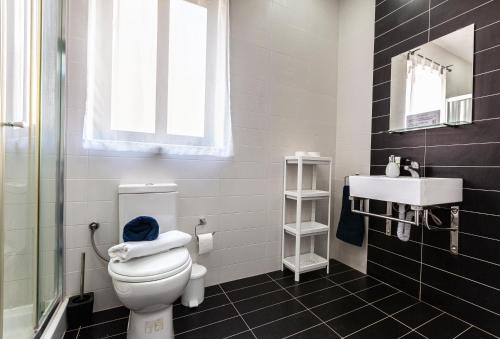 a bathroom with a toilet and a sink at Z4 - SEAFRONT apartment in St. Paul's Bay