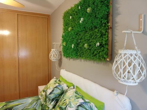 a green plant on the wall of a bedroom at Sol de Poniente in Salamanca