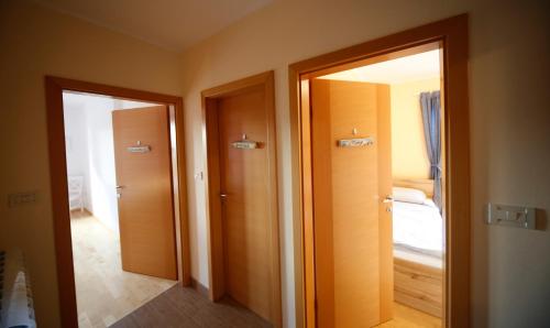 two doors in a room with a bedroom at KIŽIN House, Cozy apartments by Istrian Embrace in Brezovica pri Gradinu