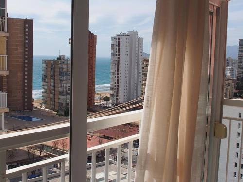 a view of the ocean from a balcony with a curtain at virginia-48 in Benidorm