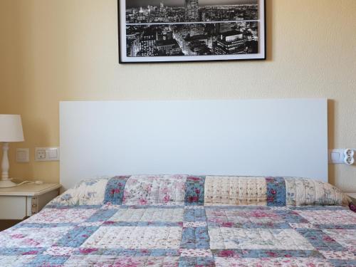 a bedroom with a bed with a quilt on it at Novo Sancti Petri Atardecer planta primera in Chiclana de la Frontera
