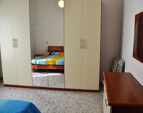 a bedroom with a bed and a mirrored cabinet at La Casa di Pedaso in Pedaso