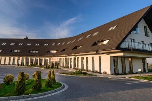 a large building with a brown roof at Hotel Bachledówka in Zakopane