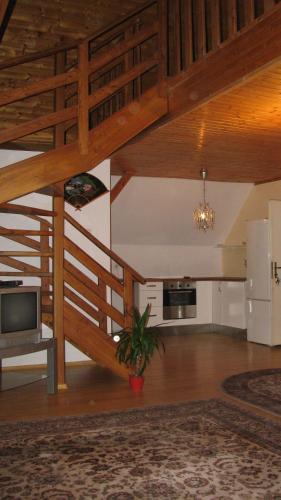 a large living room with wooden ceilings and a potted plant at Apartmány Sedmikráska in Tehovec