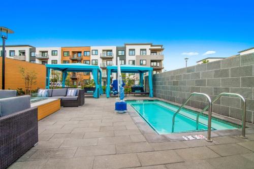 a pool with a gazebo next to a building at Churchill Living at Anton Menlo in Menlo Park