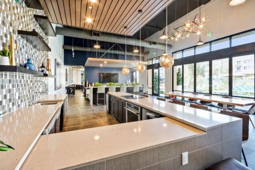 a large kitchen with white counter tops and windows at Churchill Living at Anton Menlo in Menlo Park