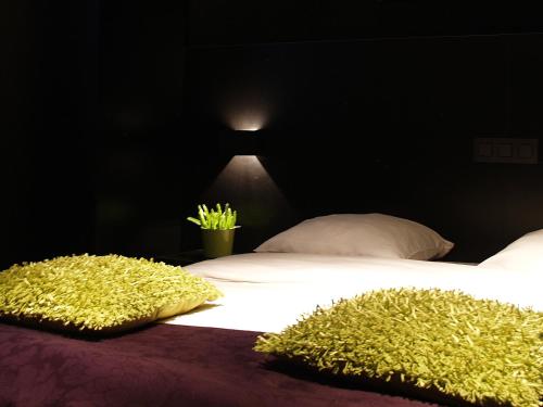 a bedroom with a bed with two pillows on it at Hotel Florent in Lier