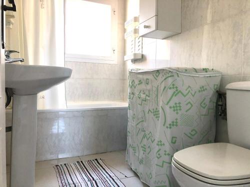 La salle de bains est pourvue de toilettes et d'un lavabo. dans l'établissement NAUTICA 10 - Apartamento terraza con vistas al mar - aire acondicionado - cerca puerto, playa y centro, à Roses