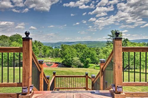 a wooden deck with a view of a field at Red Sweetheart Barn Studio with Mtn and River Views! in Westminster