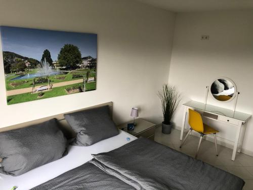 a bedroom with a bed with a picture on the wall at Apartment AusZeit in Bad Kissingen