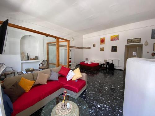 a living room with a red couch and a floor covered in water at La Tela Bianca in Naples
