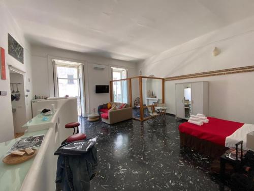 a large living room with a red bed and a room with at La Tela Bianca in Naples