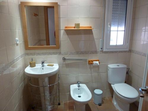a bathroom with a toilet and a sink at Can Panxeta in Pallaresos