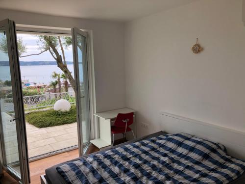a bedroom with a bed and a view of the ocean at Portorož Apartments in Portorož