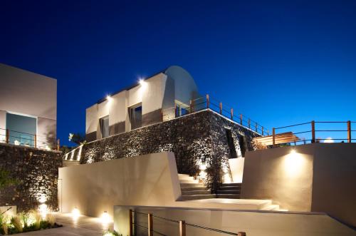 a villa with a staircase leading up to it at night at Melidonia Suites in Akrotiri