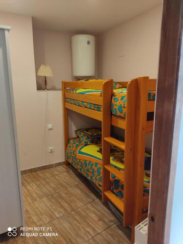 a bedroom with two bunk beds and a lamp at Casa Bera in Arnedillo