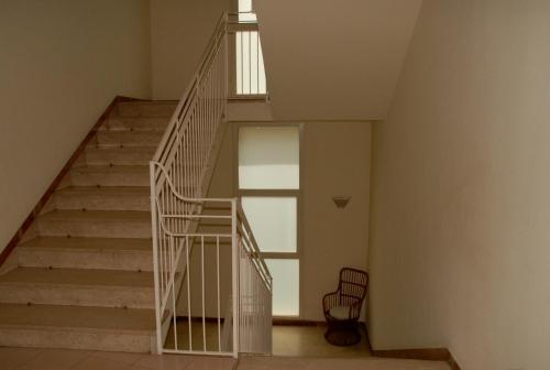 a staircase in a building with a stair case at Hotel Arno in Rimini