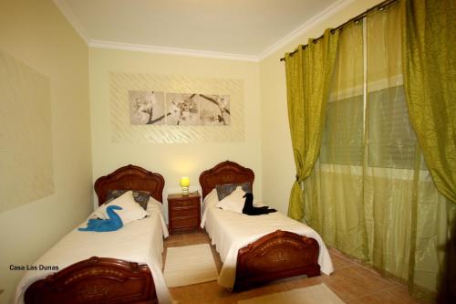Postel nebo postele na pokoji v ubytování Casa las Dunas