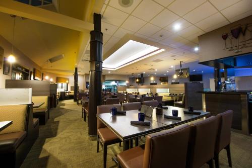 a dining room with tables and chairs in a restaurant at Victoria Inn Hotel & Convention Centre Brandon in Brandon