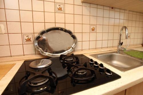 a kitchen with a stove top with a sink at Sea view apartment Umag 2 in Umag