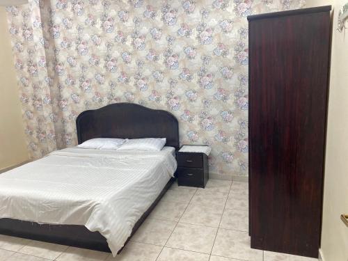 Säng eller sängar i ett rum på Al Awael Furnished Units