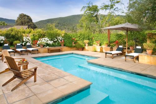 a pool with a pool table and chairs in it at Bernardus Lodge & Spa in Carmel Valley