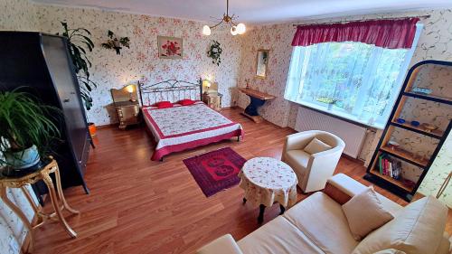 salon z łóżkiem i kanapą w obiekcie Pensjonat Nostalgia w Kołobrzegu