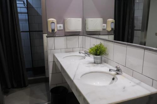 a bathroom with two sinks and a mirror at HelloBCN Youth Hostel Barcelona in Barcelona