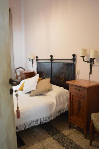 a bedroom with a bed and a wooden dresser with pillows at B&B Lady Cocca in Savio di Ravenna