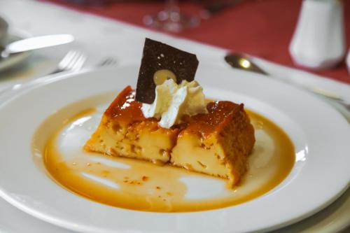 a piece of cake on a plate on a table at Hotel Diego de Almagro Punta Arenas in Punta Arenas