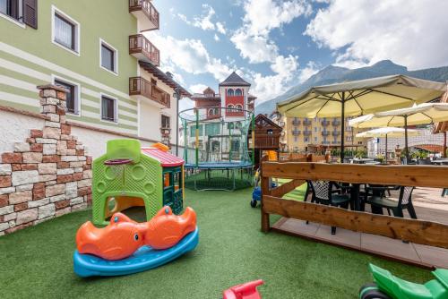 a playground with a toy train and a table at Hotel Ghezzi in Andalo