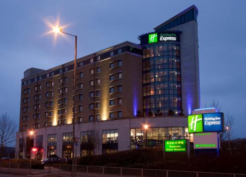 
a large building with a clock on the side of it at Holiday Inn Express London Greenwich, an IHG Hotel in London
