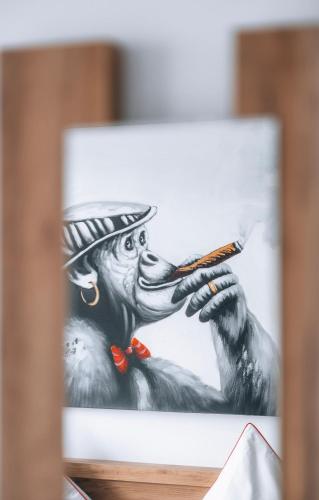a drawing of a monkey holding a cigarette at Sleep Point - Self Check in Hotel in Bremen