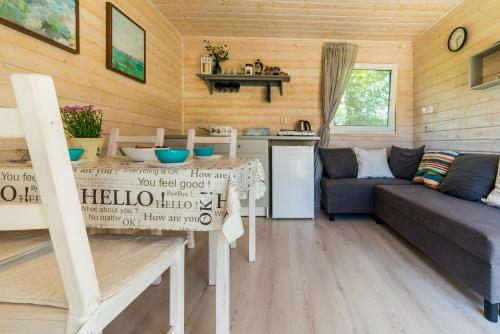 a small living room with a couch and a table at Domki u Polki in Sławoszyno