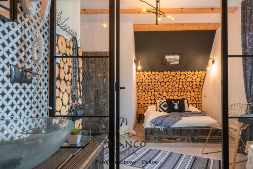 ザコパネにあるWilla Bianco Zakopaneのベッド1台とガラスドアが備わる客室です。