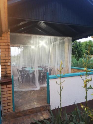 a covered patio with a table and chairs at ZEN - VIKENDICA in Bezdan