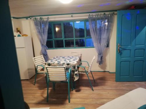 a dining room with a table and chairs and a window at ZEN - VIKENDICA in Bezdan