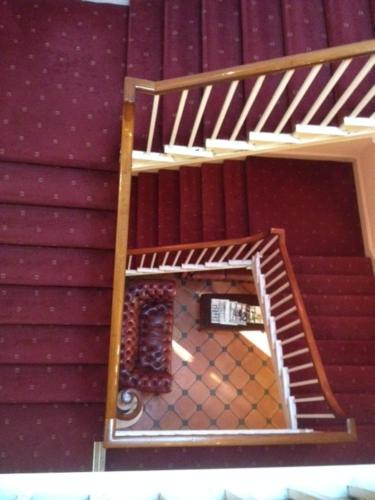 a staircase in a room with a mirror at The Royal Victoria & Bull Hotel in Rochester