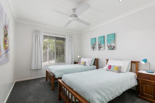 ein Schlafzimmer mit zwei Betten und einem Fenster in der Unterkunft Amalfi in Point Lookout