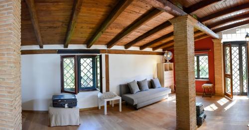 a living room with a couch and a stove at Villa di Lago Albano - Castel Gandolfo in Albano Laziale