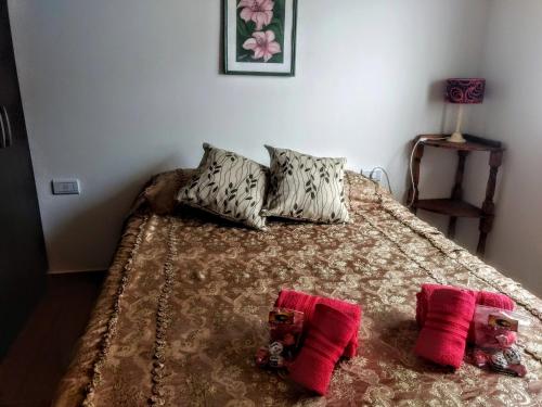 a bedroom with a bed with two stuffed animals on it at View Point Apart Pino in Villa Giardino