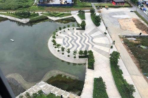 an aerial view of a park with a lake at Enjoy Modern, Spacious, Peaceful stay with Lake view - Gravit8 in Klang