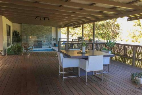 a patio with a table and chairs on a deck at Arthouse Six in Margaret River Town