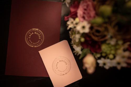 a wedding invitation and a card next to a bouquet of flowers at Casa Hoyos - Hotel Boutique in San Miguel de Allende