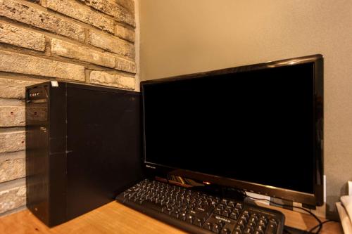 a computer monitor and keyboard sitting on a desk at Welkin Hotel in Busan