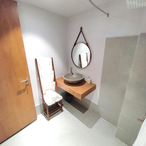 a bathroom with a sink and a mirror at Cagina Boutique Hostel in Dong Hoi