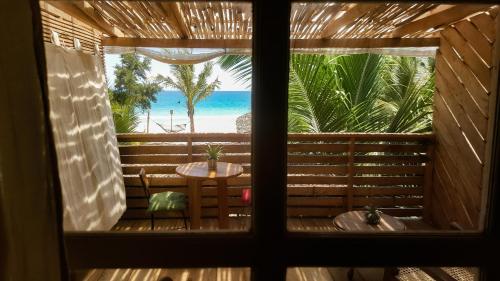 a window view of the beach from a resort room at Memo's Beach in Nilaveli